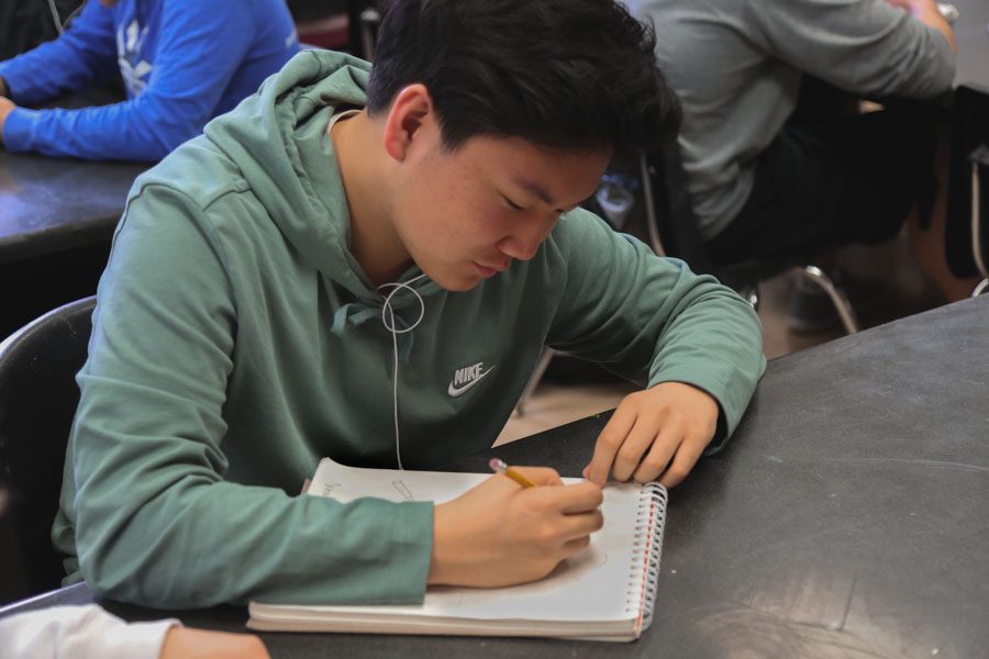 Sophomore Brandon Kim works on preparing for the printmaking process which
