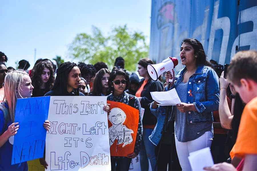 Organizer and junior Aarti Poduval makes remarks while students listen. 