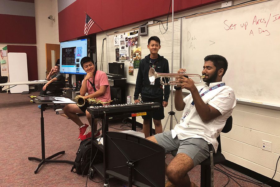 Senior Sid Sadhu plays the trumpet in hopes of making jazz band while senior Patrick Lin and sophomore Chris Xiao watch the performance.