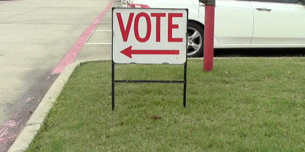Directing voters to the polling booth, signs line the campus with voting starting at 7:00 a.m. on Monday.