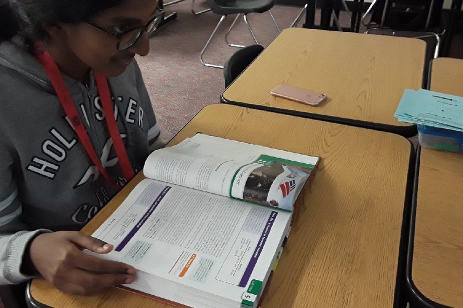 As textbooks are becoming a thing of the past, some teachers hold onto the old method of teaching while others have been more technologically focused. Senior Ramya Rajendran continues to utilizes her economics textbook in class.