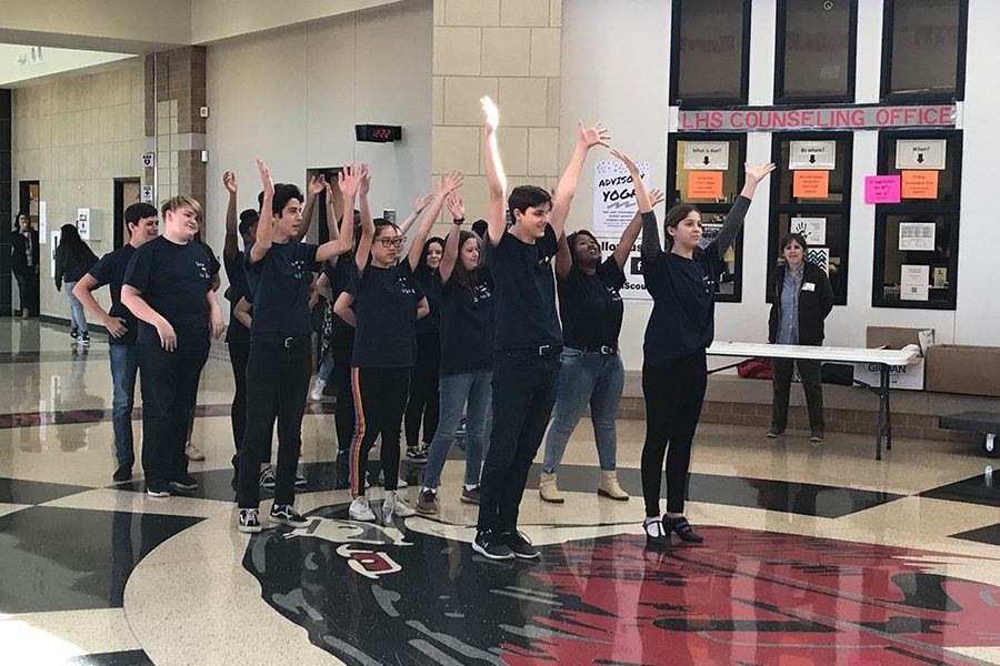 Cast members from theatres upcoming production of Singin in the Rain gave students and staff a glimpse at the show with a flash mob performance on Wednesday during advisory period. The production runs Nov. 29-Dec. 2. 