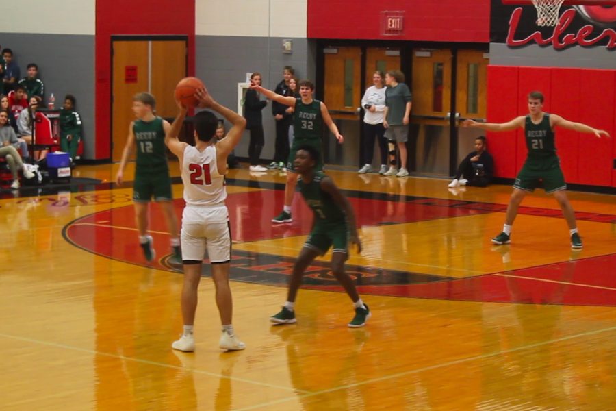 Waiting for his teammates to cut into the lane, senior Davis OBrien looks to make an entry pass in Fridays home game against Reedy. After losing its first District 9-5A game to Frisco, the boys team earned its first district win by beating the Lions 68-55. 