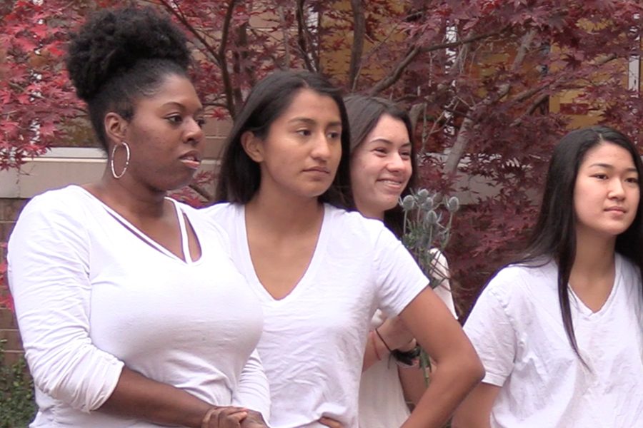 With each girl wearing white shirts and minimal make-up, junior Sarah Ajayi, junior Suzanne Ramierez, senior Kira Robinson, and sophomore Megan Gi get reading for junior Amelia Jauregui to take a group picture. 