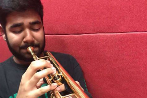 Former senior trumpet player Sid Sadhu practices his instrument to prepare to play with his group. With their eyes set on Mays Spring Swing performance, band students will begin auditions for jazz band. Many band members are excited for a new opportunity outside of  normal band practices. 