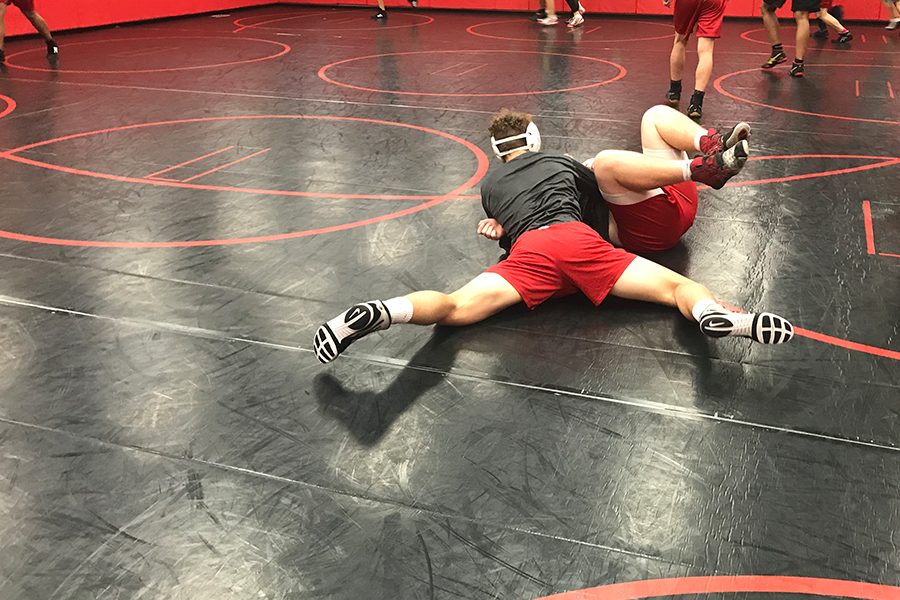 Practicing+before+Thursdays+dual+meet+against+Frisco%2C+senior+Austin+Widner+gets+junior+Ethan+Qualls+on+his+back.+Both+the+boys+team+and+the+girls+team+square+off+against+the+Raccoons+starting+at+6%3A00+p.m.+