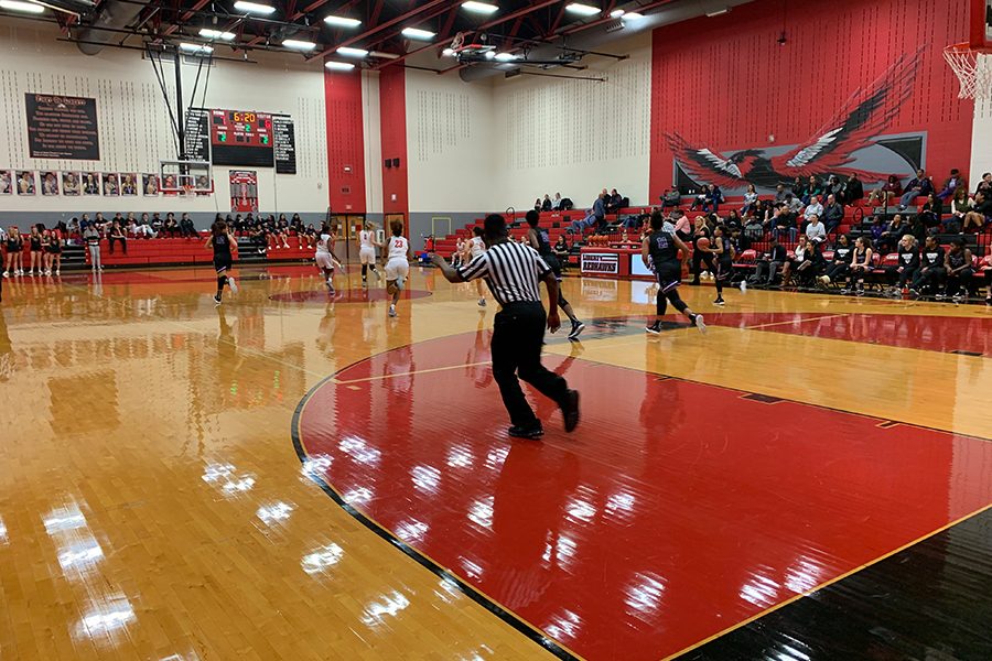 Independence gets a hold of the ball and all the players make a mad dash to the other side of the court including the referee, in hopes of stopping the Knight player from putting up a shot in the second quarter on Friday, Jan. 25 2019.
