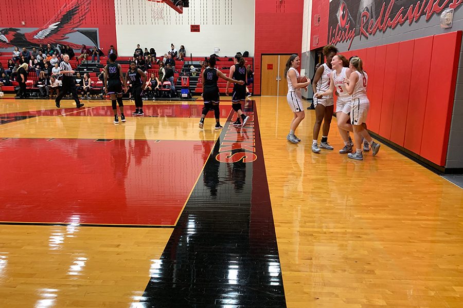 Fellow teammates go to congratulate Savannah McKeen(#5), after making a shot on Friday, Jan. 25 2019 against Independence. 