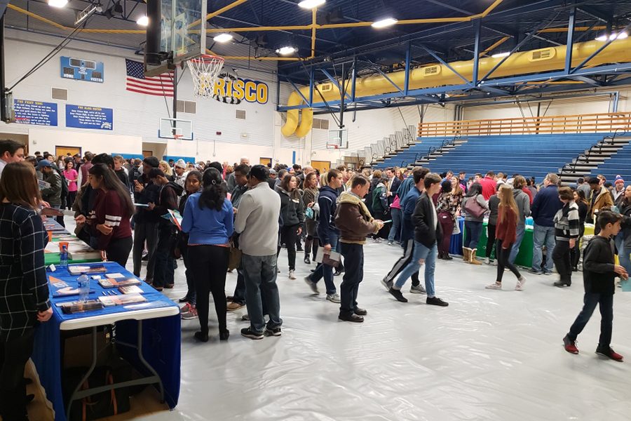 Students and parents from the FISD school district attend the FISD College fair held at Frisco High school. Attendees get the chance to speak directly with a variety of different colleges as they gain information regarding what each has to offer.