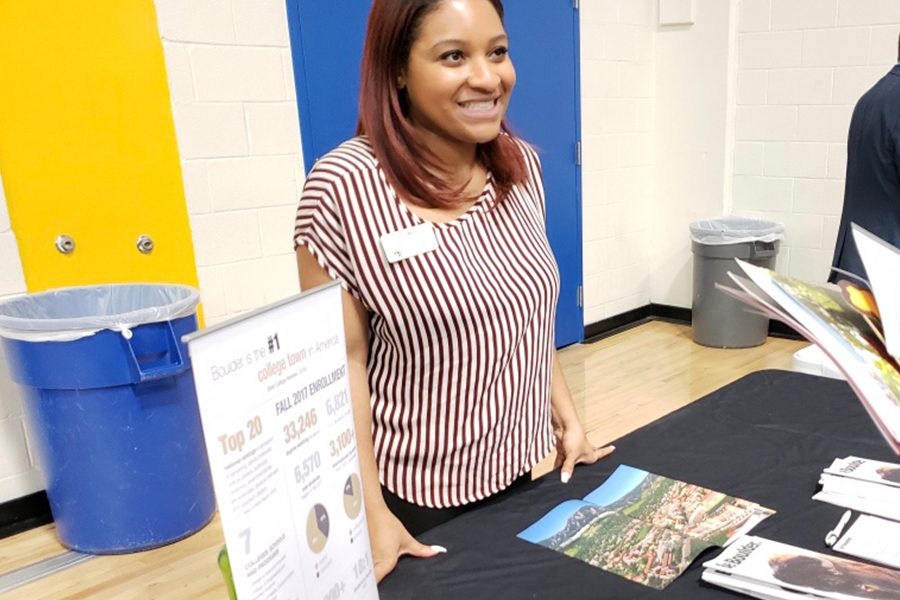 University of Colorado Boulder representative, Perri Watts, greets FISD students and parents with a smile as they approach the college informational table. Perri Watts answers various questions that parents and students have regarding the courses, campus life and choices of major at the University of Colorado Boulder.