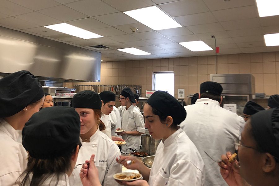 Culinary arts students are constructed models of flowers made of tootsie rolls on Wednesday. The project is meant to help students learn about keeping clean hands in the kitchen.