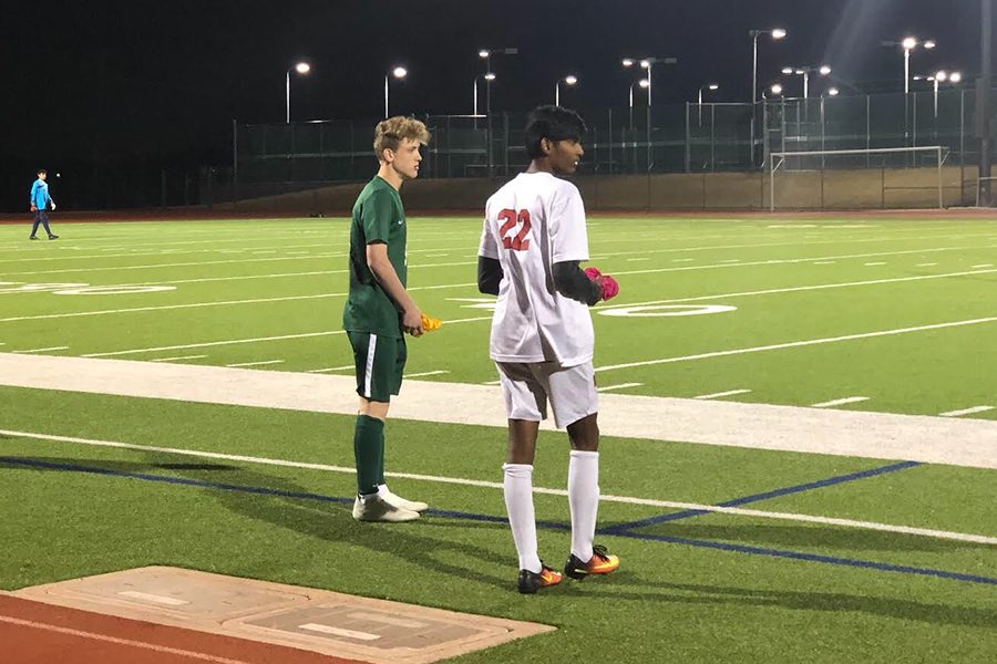 Sophomore Vishwa Pandian stands amongst Reedy defender on the sideline awaiting the continuation of the game on Friday, Jan. 18.