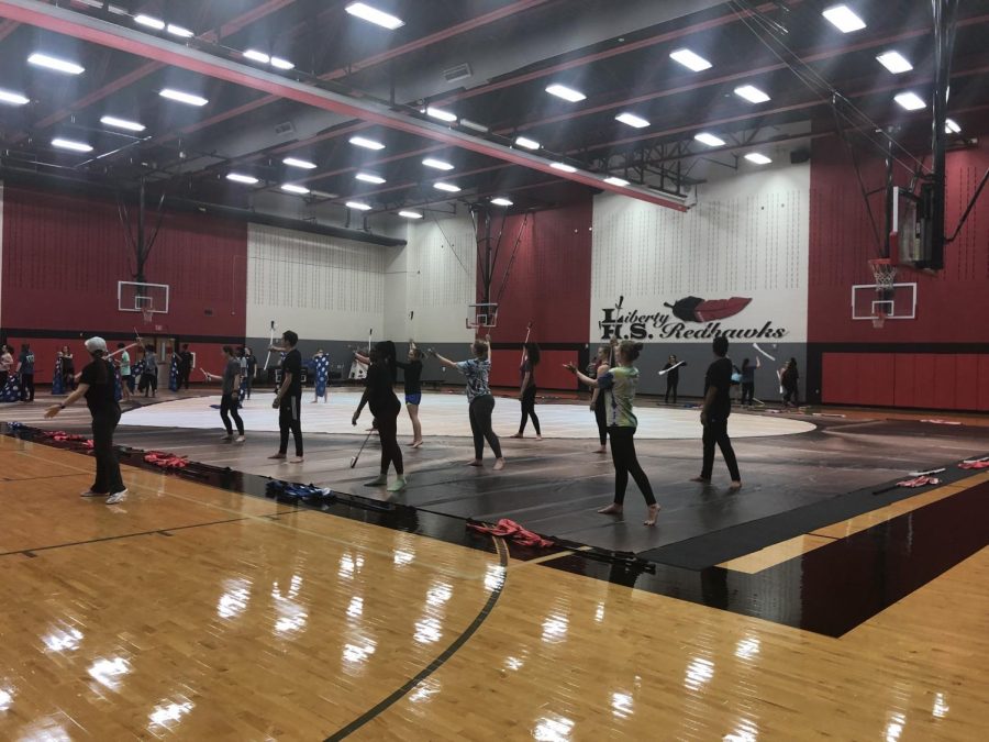 After weeks of competition, varsity winter guard is taking a break. The team looks forward to improving their performance styles.