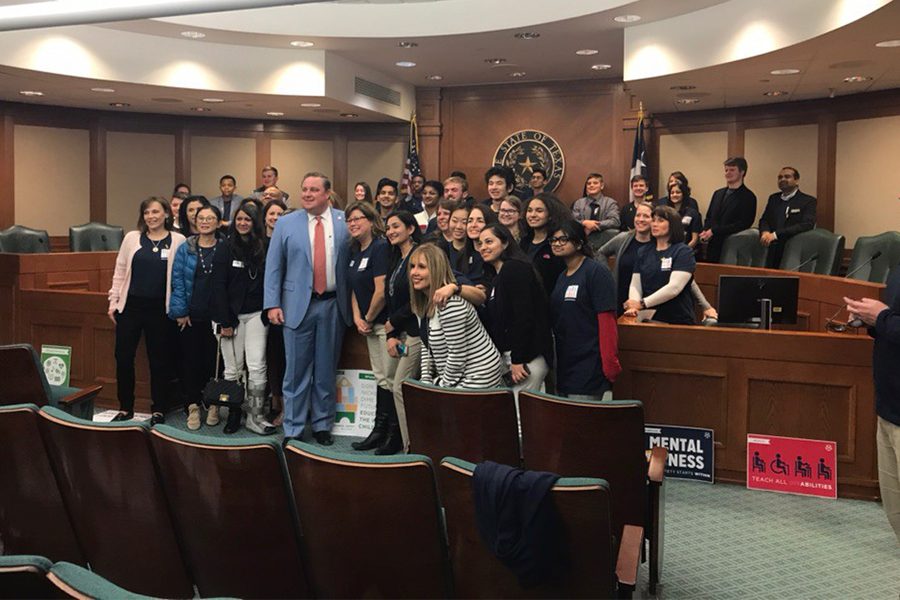 State Rep. Justin Holland (R-Rockwall) poses with students and parents after discussing funding solutions.