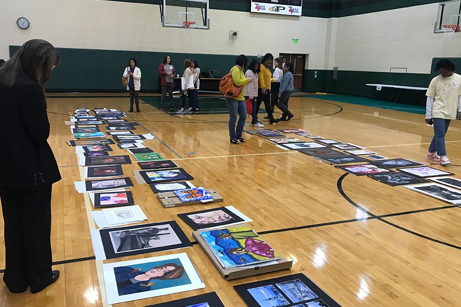 With drawings and painting lined up along the Prosper High School gym, TAEA Visual Arts Scholastic Event recognized art students in the annual VASE competition. Previously judged in person, this years event is going to be judged digitally. 