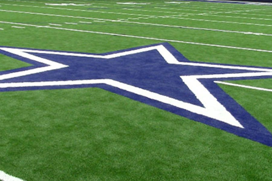 The logo of the Dallas Cowboys adorns the 50-yard line of the Ford Center at the Star. The indoor practice facility of the Cowboys, the Ford Center also hosts Frisco ISD football games in the fall. The Star opened in 2016. 
