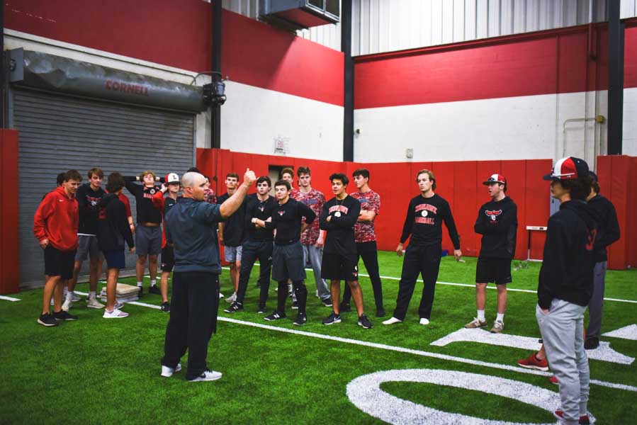 Practicing+in+the+fieldhouse%2C+head+baseball+coach+Scott+McGarrh+talks+to+the+team+at+a+recent+practice.+After+playing+three+non-district+teams+in+a+tournament+March+1-2%2C+the+Redhawks+returned+to+District+9-5A+play+Wednesday%2C+falling+to+Reedy+6-5.