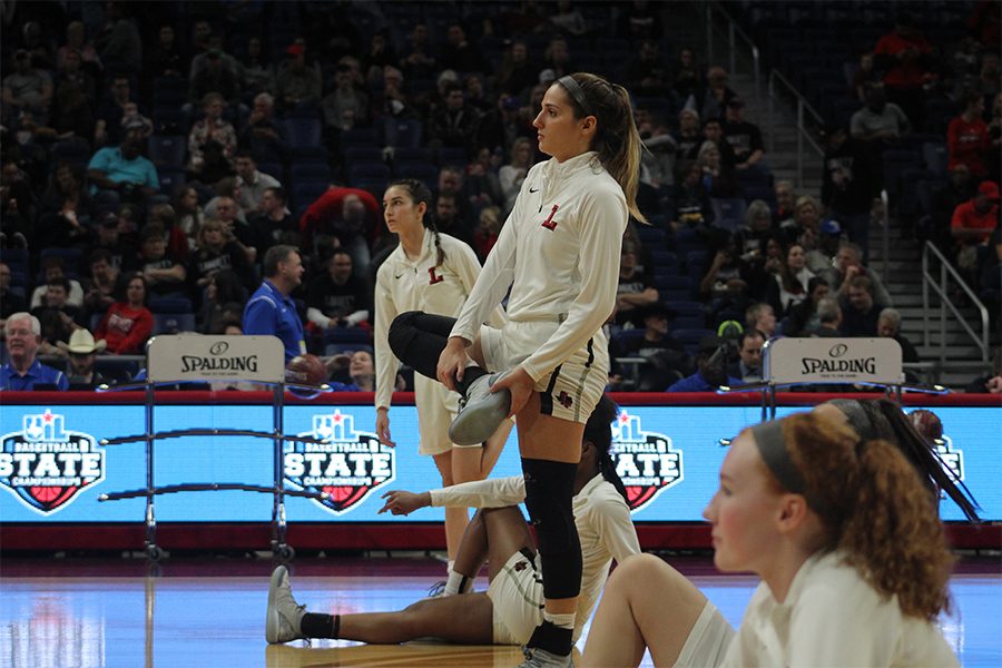 Before the game, senior Alyssa Nayar and her teammates stretch on the floor of the Alamodome. For some seniors, this is the second time taking the court for a chance to obtain a state championship.
