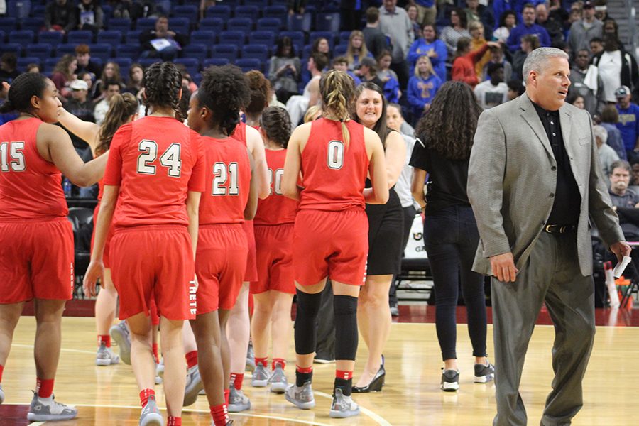 Campus athletic director Chris Burtch walks away from the team after the Redhawks 34-28 win the UIL 5A state semifinal against Kerrville Tivy. The team went more than 12 minutes without scoring but never gave up the lead. 