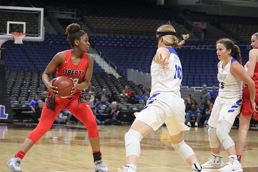 Guarded by Tivys Julia Becker (#10), senior Randi Thompson looks to make a move in the 5A state semifinal game at the Alamodome in San Antonio. Thompson would finish with a game high 16 points and six steals in the Redhawks 34-28 win. 