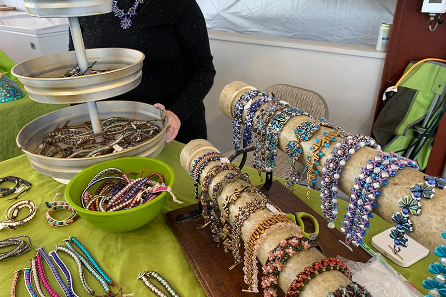During the Frisco Fair, Ariel Oetegon, owner of Arignar Designs, tends a stand with her beaded bracelets, earrings and necklaces. All of the jewelry is handmade by Oetegon and placed on display for fair attendees to purchase. 
