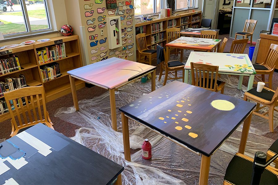 Various painted library tables are set aside in Liberty High School’s library. Librarian Chelsea Hamilton, requested Liberty art students to paint various library tabes in order to bring more life and creativity to the school library.