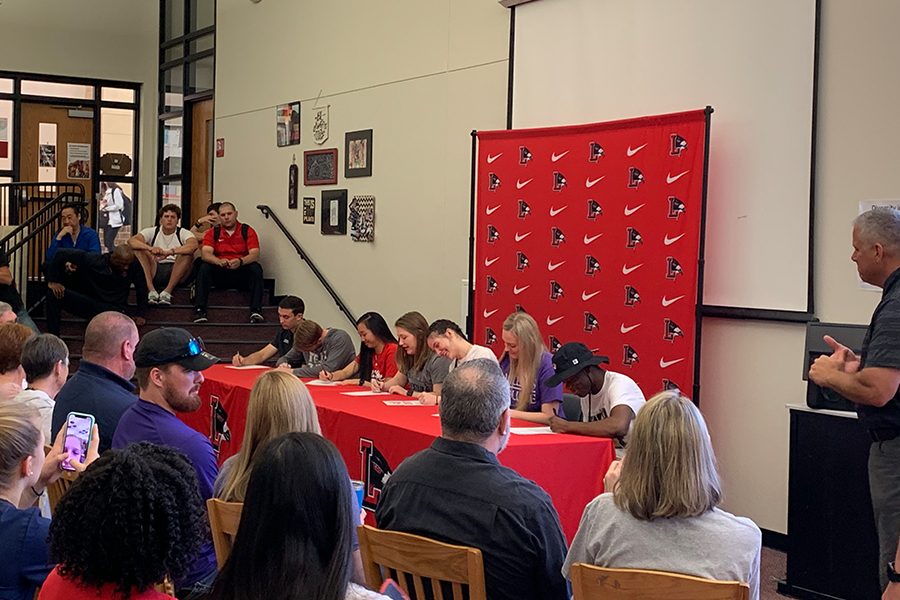 Seniors Andrew Ashmore, Dalton Stewart, Kailyn Lay, Ashley Cook, Jordan Johnston, Regan Cooper, and Precious Essien (left to right) signed on to continue their athletic careers in college on Wednesday Morning in the library.