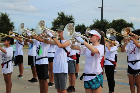 Pictured: Redhawk band students practice new show routine in parking lot during a previous summer. Due to school renovations, band students will be spending majority of practice time at Vandeventer Middle School. 