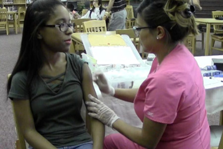 In a screenshot from a past WTV story, former Redhawk Aliza Porter receives a flu shot during Frisco ISDs flu clinic from a previous year. Frisco ISD is sponsoring its annual clinic on campus Tuesday from 3:30-6:00 p.m., delivering flu shots to all students and teachers, as long as minors are accompanied by a parent. 