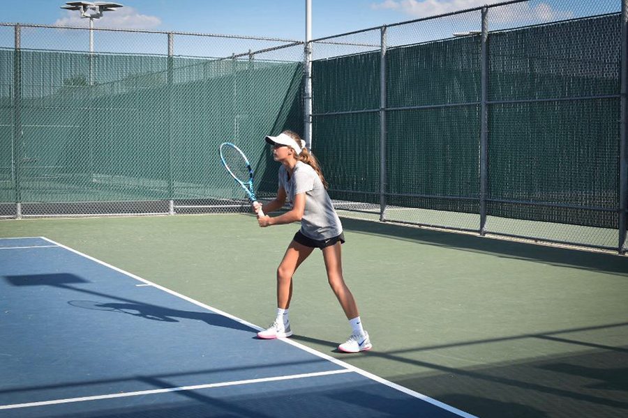 Sophomore Milla Dopson prepares during practices for upcoming matches. The tennis team heads to Centennial at 4:00 p.m. for the first match of the season. 