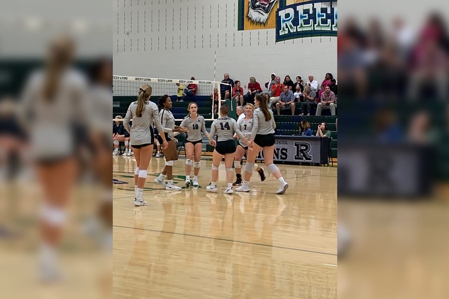 Celebrating after another point was scored, the Redhawks volleyball team earned a 3-0 victory over the Reedy Lions Tuesday. The win is the second straight to start District 9-5A play, with the team back in action Friday against Centennial.