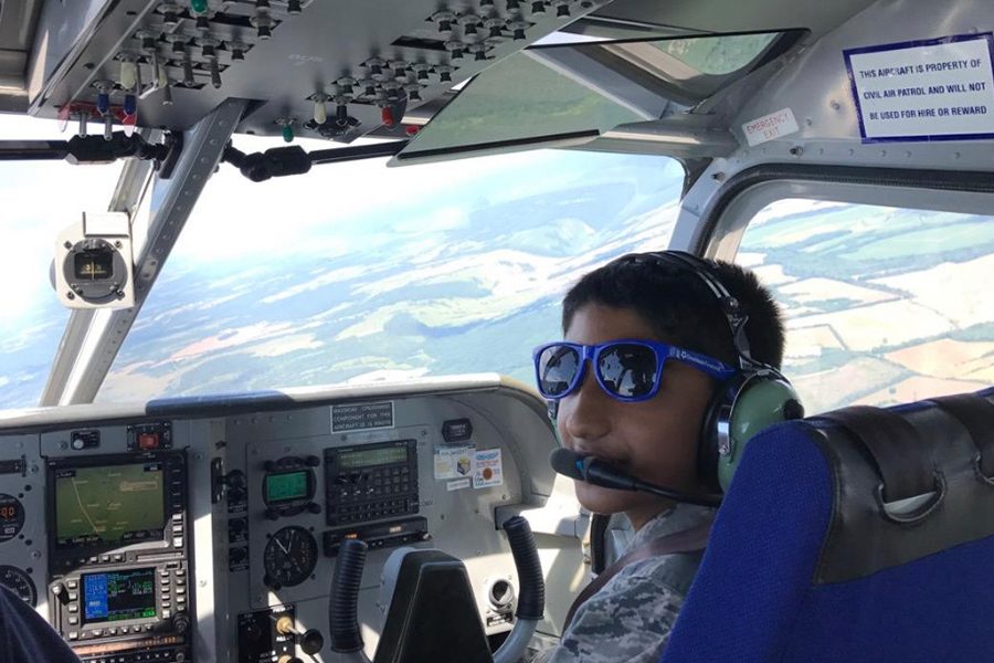Freshman Akash Pradeep sits in the cockpit of an aircraft operated by the Civil Air Patrol. Pradeep fell in love with flying as a scout in Virginia.