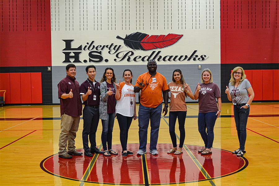 UT Austin and A&M alumni on the campus faculty pose in the gym. Redhawks have the chance to learn about both colleges tomorrow at the Texas Together Night.
