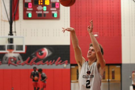 Preparing for this seasons competition, senior Eric Lynn shoots the ball in practice. Though the Redhawk boys came up short against the Raccoons, the team is looking forward to future competitions. 