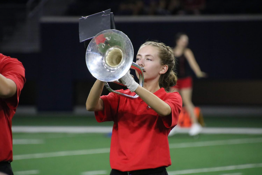 During bands halftime performance, Marin Webber marches with her fellow band students. As a french horn player, Webber is a crucial part of the ensemble, and adding different musical layers to the performance. 