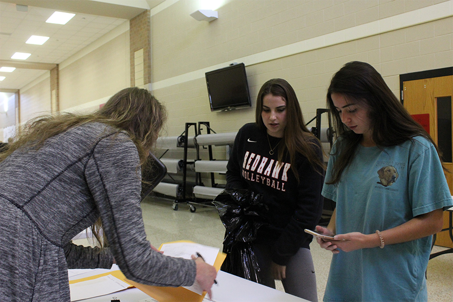 Juniors Franny Terreza and Emily Chladny help with last minute donations. Tuesday was the last day for angel donation during second period B-day classes.  