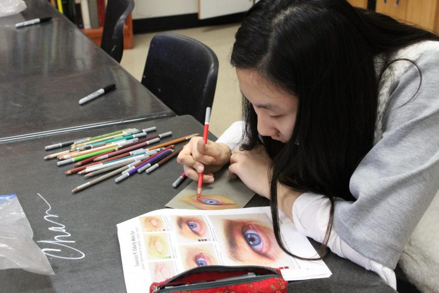 Elly Kong works on the technique of drawing a realistic eye with pastel pencils. AP Drawing students will use these techniques to draw realism portraits.  