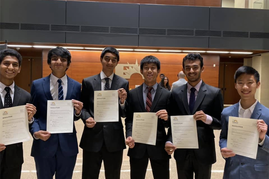 Students (from left to right) junior Tom Punnen and seniors Kapil Rampalli, Keshav Narasimhan, Johnathan Peng, Kunal Dhawan, and Zachary Suzuki hold up certificates. The six Redhawks were among other students honored at the school board meeting Monday night for receiving a perfect score on the SAT or ACT.