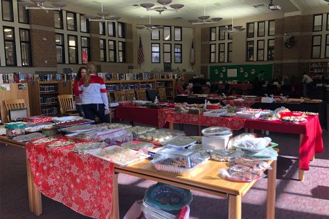 PTSA members help to fill the library with cookies baked by the community. Staff had the chance to bring cookies home to their family as part of the exchange.