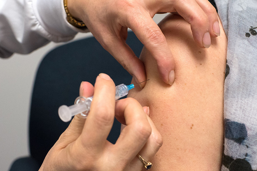 A woman receives a vaccination for the flu virus in her upper arm. With flu season nearing, the campus is opening a flu clinic on Wednesday.