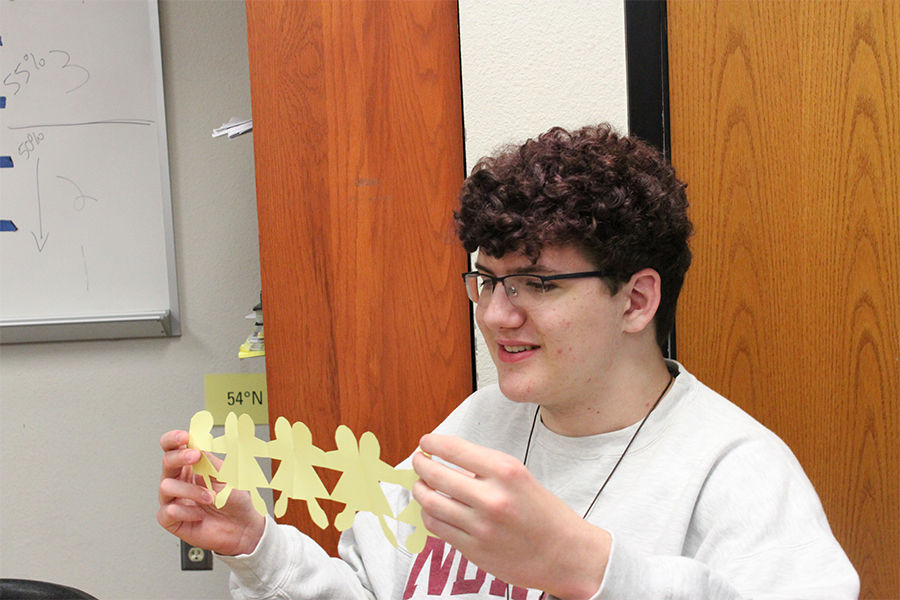 The first step in the project for freshman Adam Walker was to cut out a paper doll chain. From there, the students had to write facts about the role of women in agriculture on the paper doll chains. 