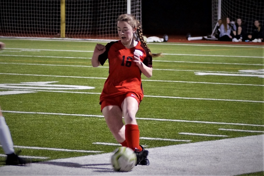 Junior, Emerie Jones runs across the field with the ball. Both boys and girls team play the Knights Friday with the boys at home and the girls away.