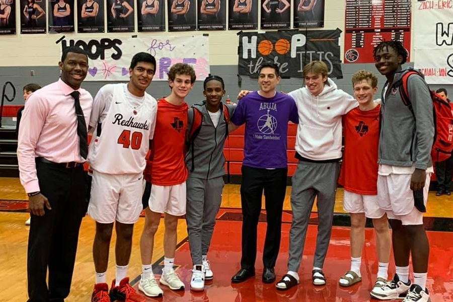 Standing with all of the teams seniors, Philips and his teammates smile for the camera after their senior night matchup with Reedy High School. 
These seniors have dedicated their high school years to the Redhawk basketball program, and for Philips, the game was an opportunity to step on to the court with these boys for the last time. 