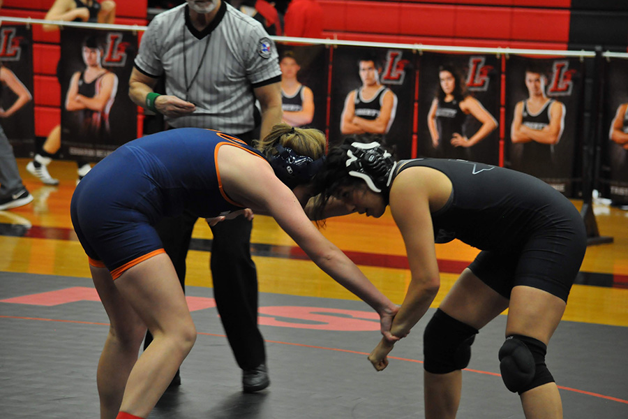 Squaring up with an opponent from Wakeland, senior Karina Quiros looks to set up for a shot. Taking a win, Quiros got to celebrate a victory for not only her senior night, but her last home dual as a Redhawk. 