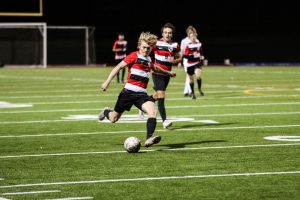 Winding up a kick, junior Jack Bryan prepares to take a shot at the goal. After multiple tie games finally followed by a win for both teams, the Redhawks are seeking out any points they can grab to continue their win streak.
