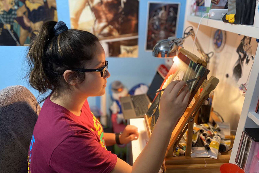 Senior Emma Varela works on an art assignment in her room at home last year during eLearning in the spring. Online art classes for the first three weeks will look different from eLearning that took place in the spring. “During eLearning we had already established skills, and a system so its going to look very different,” art teacher Fred Rodriguez said. “Students will really need to practice to develop the skills they will need throughout the year. In the spring we were limited with the amount of time we could assign to each student, but this will feel more like regular school, except online.” 
