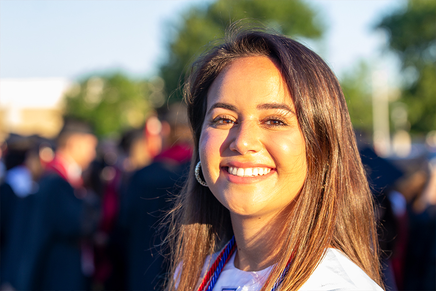 Standing outside Toyota Stadium, senior Yael Even is all smiles before her graduation on Saturday, May 30, 2020. 