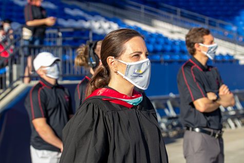 Wearing her Frisco ISD class of 2020 graduation masks provided by Jostens, principal Ashley Rainwater stands on the field at Toyota Stadium for graduation on Saturday, May 30, 2020. 