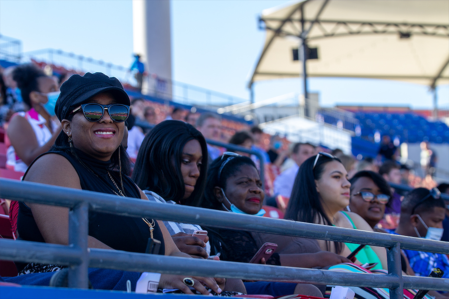 Family members of a class of 2020 graduate sit in the shade at Toyota Stadium on Saturday, May 30, 2020 for the class of 2020 graduation. 