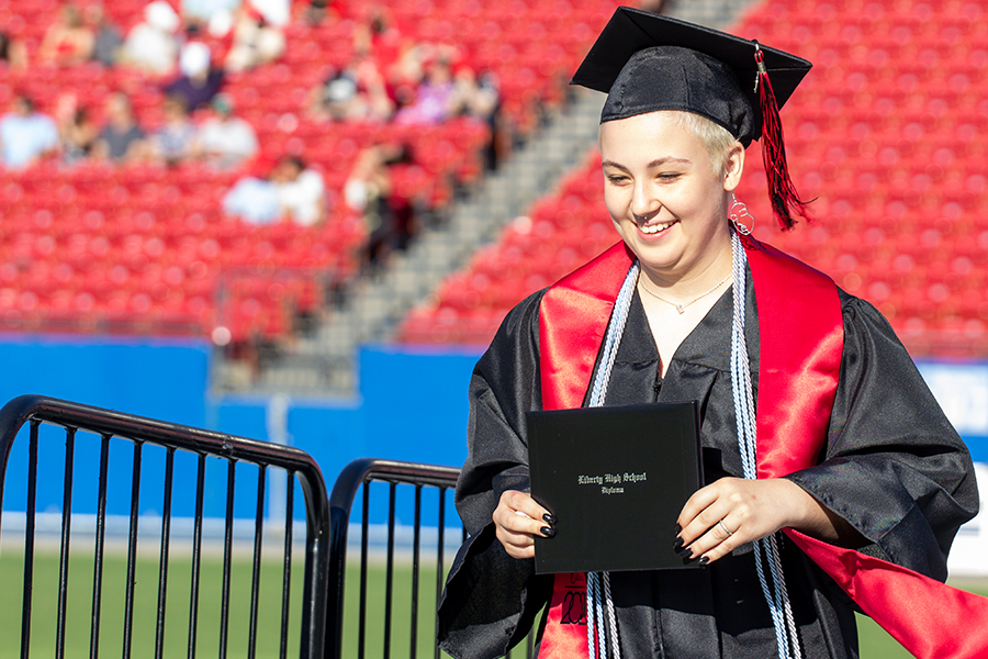 Senior Maddie Aronson makes her way across the stage at Toyota Stadium for the class of 2020 graduation on Saturday, May 30, 2020. 